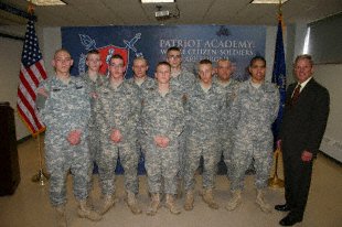 U.S. Rep. Baron Hill poses with high school graduates of the National Guard Patriot Academy, March 31st at the Muscatatuck Urban Training Center in Butlerville, Ind. The Soldiers, who were former dropouts, received accredited high school degrees and are waiting to ship out to advanced individual training.